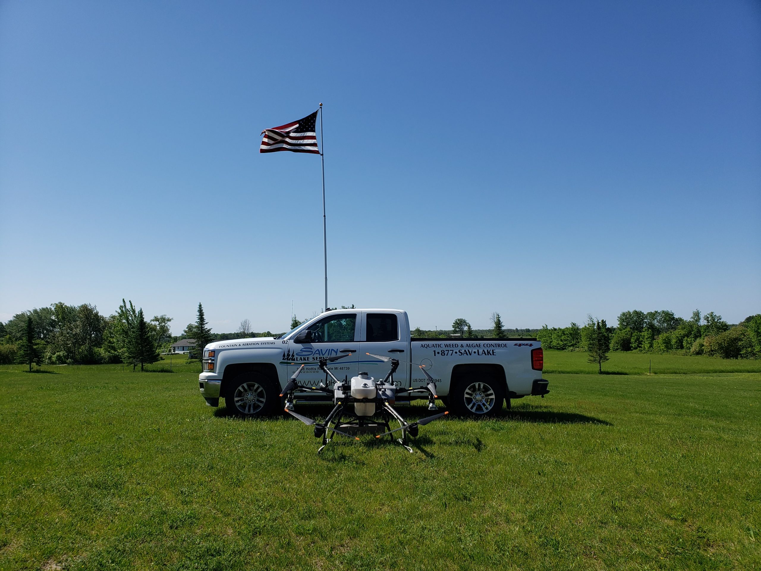 Savin Lake Services pickup truck with T-130 drone and American Flag